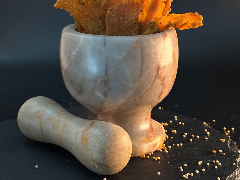 Dried mango (amchur) in a stone mortar