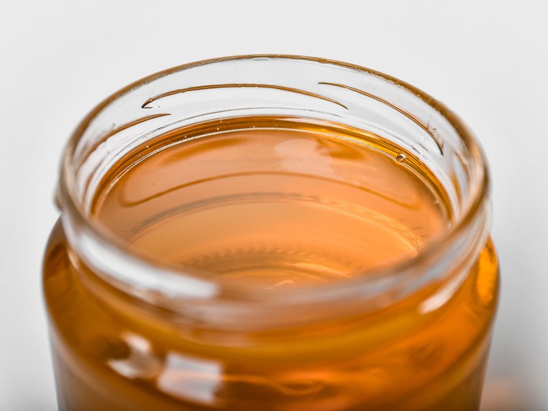Organic forest honey in a glass jar